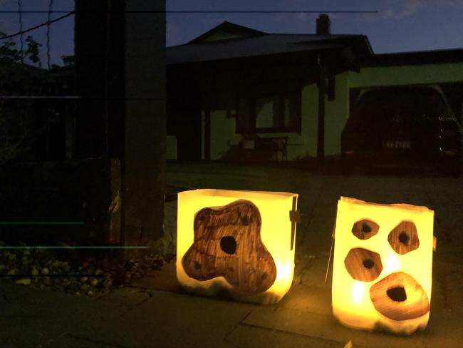 Homemade lanterns flicker in the light of early dawn at Colonel Light Gardens. Photo Jessica Leo-Kelton.