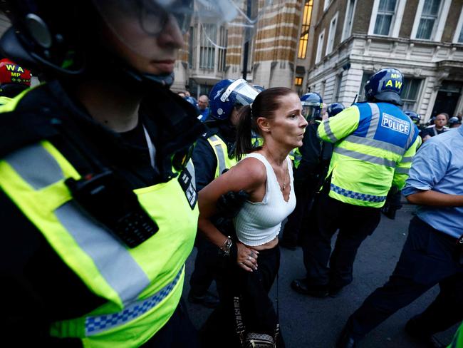 Police officers detain a protestor during the 'Enough is Enough' demonstration on Whitehall, outside the entrance to 10 Downing Street in central London. Picture: AFP