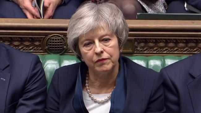 Theresa May listens as Labour Party leader Jeremy Corbyn informs the Commons that he has tabled a vote of no confidence in the Government.