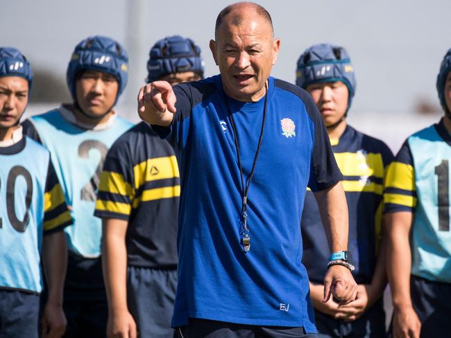 (FILES) This file photo taken on November 1, 2019 shows then-England head coach Eddie Jones (C) leading a rugby practice session with Japanese schoolchildren after the England captain's run at the Fuchu Asahi Football Park in Tokyo during the Japan 2019 Rugby World Cup. Eddie Jones would "definitely be interested" in coaching Japan but has yet to receive an offer, Japanese media reported on November 8, 2023, the former England and Australia coach as saying. (Photo by Odd ANDERSEN / AFP)