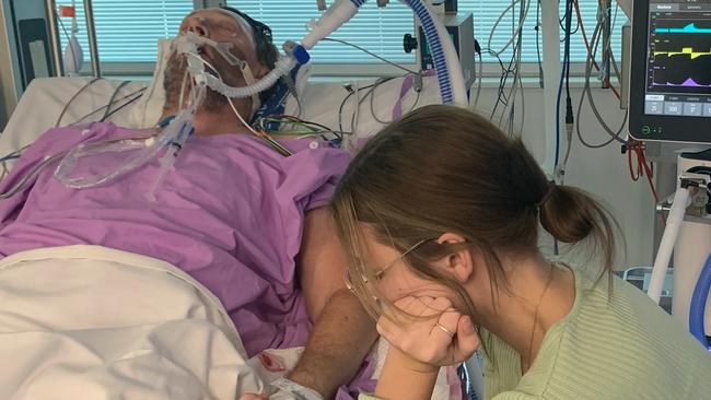 Maddie Roscoe watches over her dad Chris Roscoe in hospital. Photo: supplied