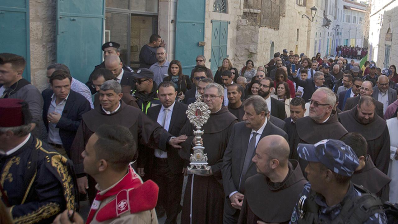 People parade through the streets of Bethlehem with a wooden relic believed to be from Jesus' manger on November 30, 2019. Picture: AP