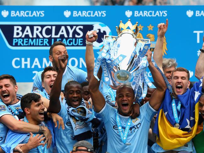 MANCHESTER, ENGLAND - MAY 11: Vincent Kompany of Manchester City lifts the Premier League trophy at the end of the Barclays Premier League match between Manchester City and West Ham United at the Etihad Stadium on May 11, 2014 in Manchester, England. (Photo by Alex Livesey/Getty Images)