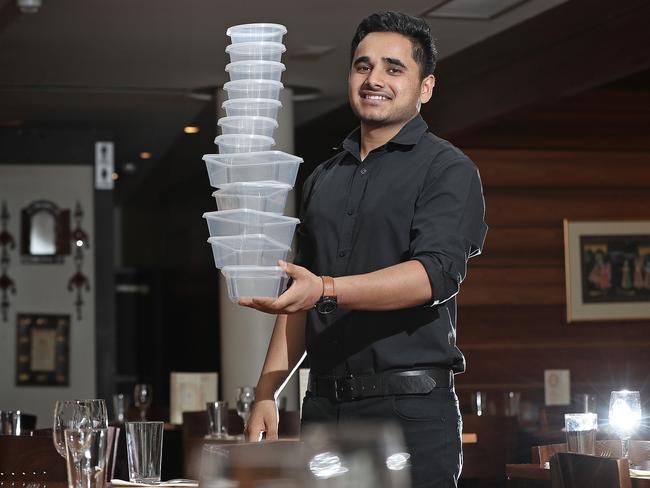 Parveen Panwar, from Annapurna Indian Restaurant, with single-use takeaway containers. Picture: LUKE BOWDEN