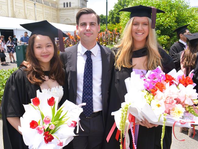 Dr Emma Pham (Doctor of Dental Surgery), Max Burrows and Dr Louisa Taylor (Doctor of Dental Surgery) at the University of Melbourne graduations held at the Royal Exhibition Building on Saturday, December 7, 2024. Picture: Jack Colantuono