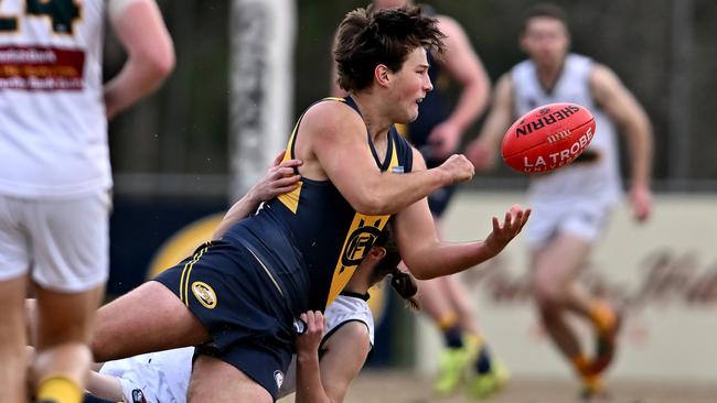 NFL: Hurstbridge’s Bryce East gets a handball away under pressure. Picture: Andy Brownbill