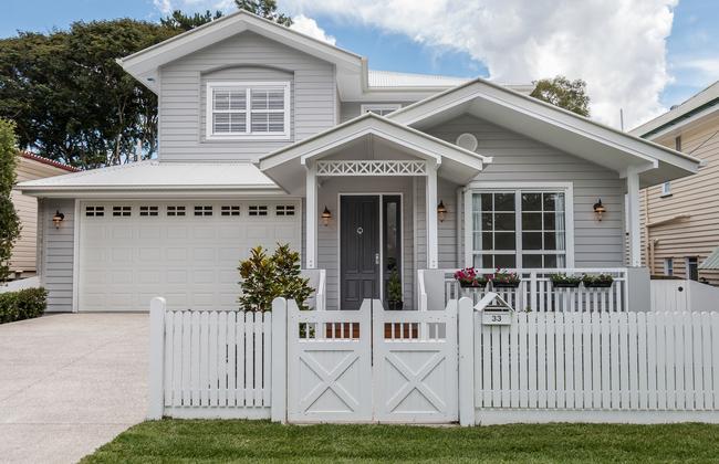 Exterior style is all about cladding with mouldings around windows and barn-style gates creating details.