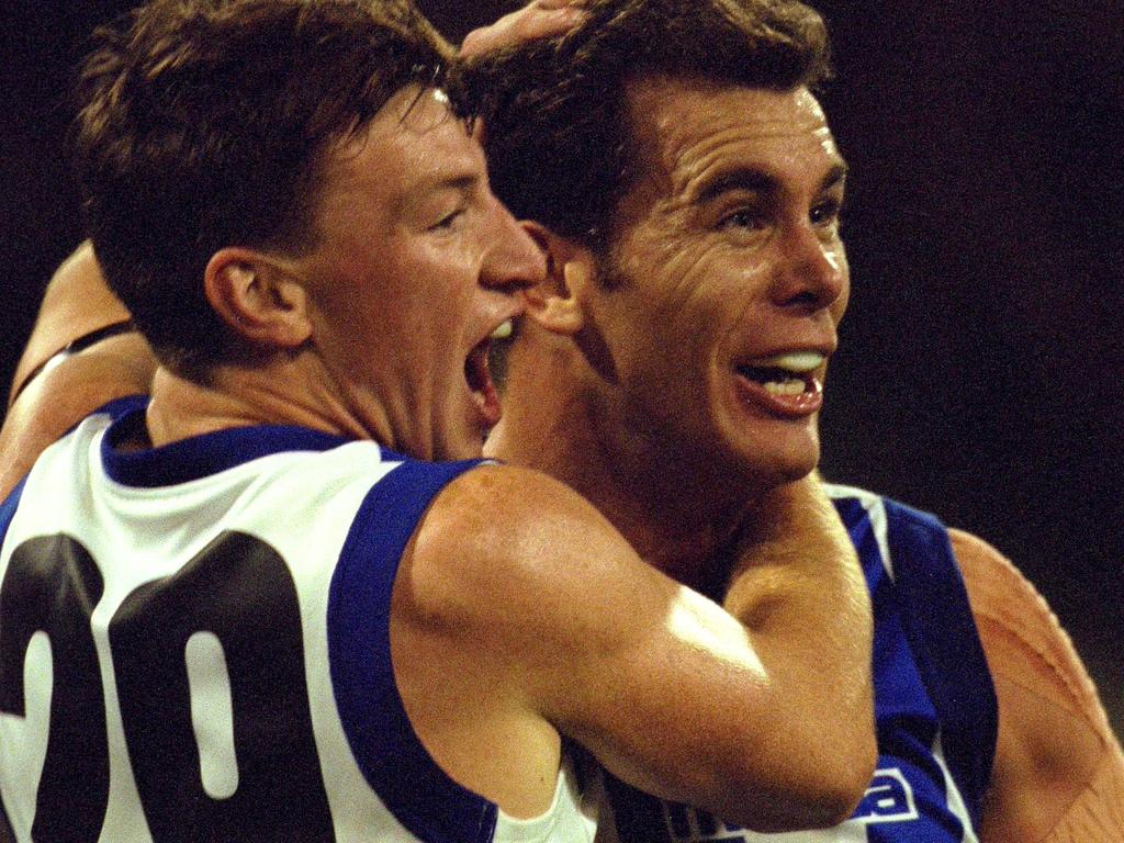 A young Brent Harvey with Wayne Carey in 2000. Picture: Hamish Blair