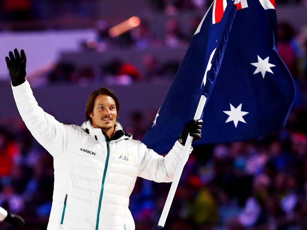 Snowboarder Alex Pullin carries Australia’s flag during the Opening Ceremony of the Sochi 2014 Winter Olympics.