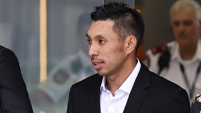 Lam Quoc ÃChopsÃ Ta (centre), a convicted drug trafficker and co-accused of lawyer Adam Magill, leaving Brisbane Supreme & District Court. Pics Tara Croser.