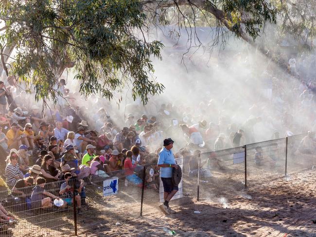 The Henley on Todd crowd cops shower of flour and water during the battle of the boats in Alice Springs August 19 2017. Photo: EMMA MURRAY