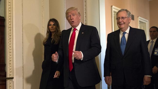 In this Nov. 10, 2016, photo, President-elect Donald Trump, accompanied by his wife Melania, and Senate Majority Leader Mitch McConnell, gestures while walking on Capitol Hill in Washington. (AP Photo/Molly Riley)