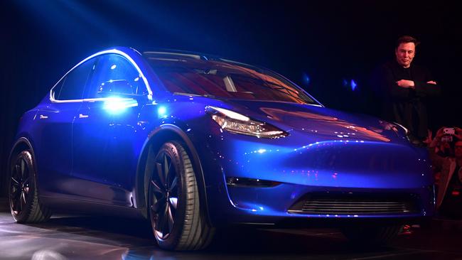 Tesla chief executive Elon Musk walks beside the new Model Y. Picture: AFP