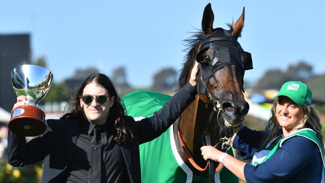 Matthew Gudinski, son of famed entrepreneur, th elate Michael Gudinski poses with Homesman after the Australian Cup on Saturday. Michael Gudinski died peacefully in his sleep at his home in Melbourne this week aged 68. Picture: Vince Caligiuri/Getty Images