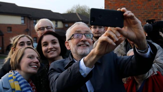 Britain's Labour Party leader Jeremy Corbyn with Labour candidate Hannah O'Neil, left, and activists in Milton Keynes, southern England on October 31.