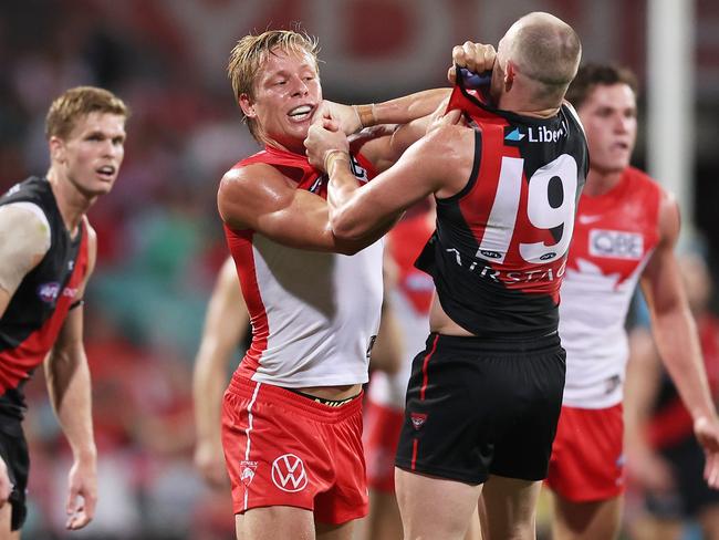 SYDNEY, AUSTRALIA - MARCH 23:  Isaac Heeney of the Swans wrestles with Nick Hind of the Bombers during the round two AFL match between Sydney Swans and Essendon Bombers at SCG, on March 23, 2024, in Sydney, Australia. (Photo by Matt King/AFL Photos/via Getty Images )