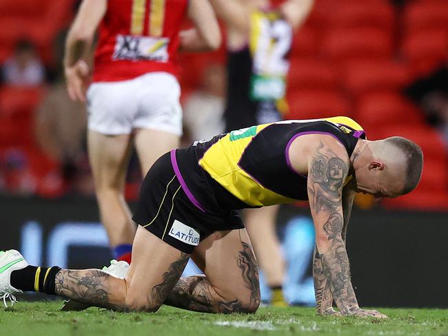 AFL Round 18. Richmond v Brisbane at Metricon stadium, Gold Coast . 16/07/2021.   Richmonds Dustin Martin on all 4s after getting injured in a collision with Mitch Robinson of the Lions  late 3rd qtr   .  Pic: Michael Klein