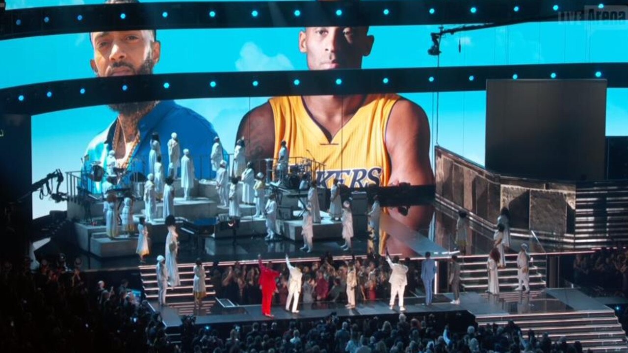 DK Khaled and John Legend performed as Kobe and Nupsey Hussle's photos appeared on screen.