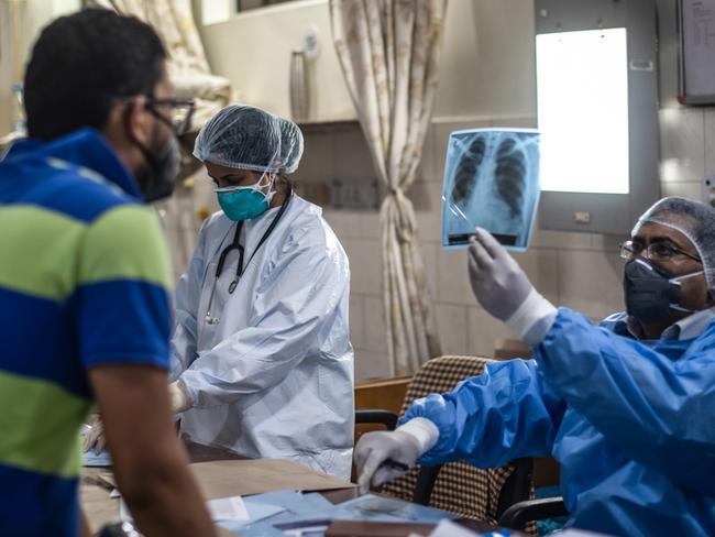 Medical staff attend to COVID-19 positive patients in the emergency ward at the Holy Family hospital in New Delhi. Picture: Rebecca Conway