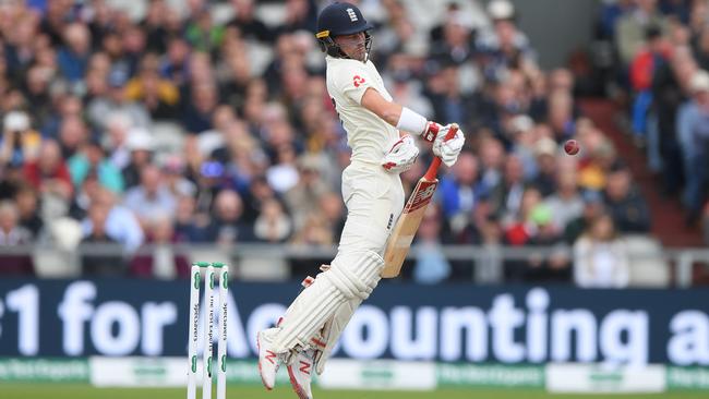 Rory Burns fends off a short ball from Pat Cummins. Picture: Getty Images