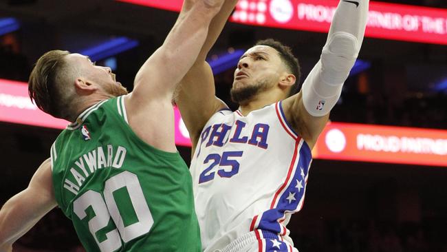 Philadelphia 76ers' Ben Simmons, right, shoots against Boston Celtics' Gordon Hayward.