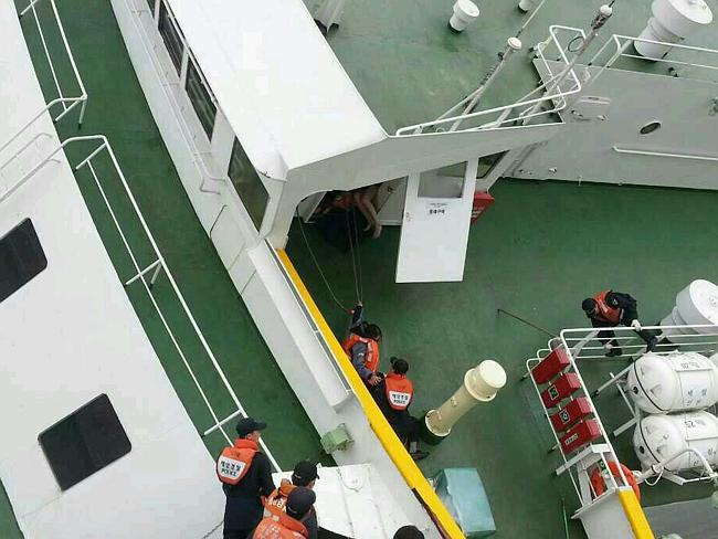 The rescue mission ... passengers rescued by coast guard members from the Sewol ferry sinking off the coast of Jindo Island. Picture: The Republic of Korea Coast Guard