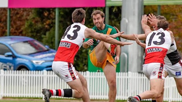 North Albury coach Tim Broomhead is surrounded by three Myrtleford opponents. Picture: Tim Petts (supplied)