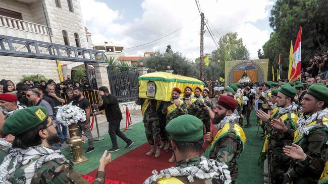 Hezbollah members carry the coffin of a comrade in Adloun in southern Lebanon on Thursday. Picture: AFP