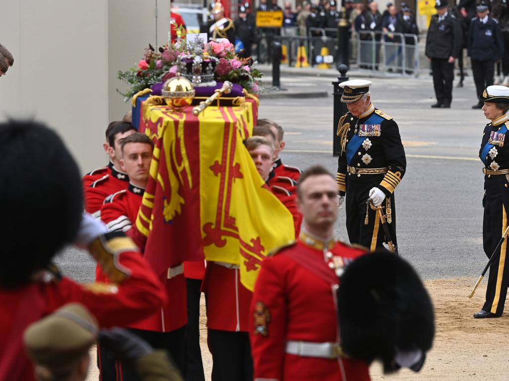 King Charles III and Princess Anne, Princess Royal walk behind The Queen's funeral cortege borne on the State Gun Carriage of the Royal Navy.