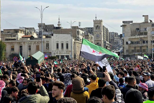 Mourners attend the funeral in the Syrian city of Hama of security forces killed by pro-Assad gunmen