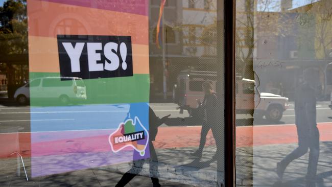 Marriage equality advocates have lost a High Court bid to stop the government’s same-sex marriage postal survey. Here, a "Yes" banner in support of same sex-marriage hangs in a window in Sydney. Picture: AFP