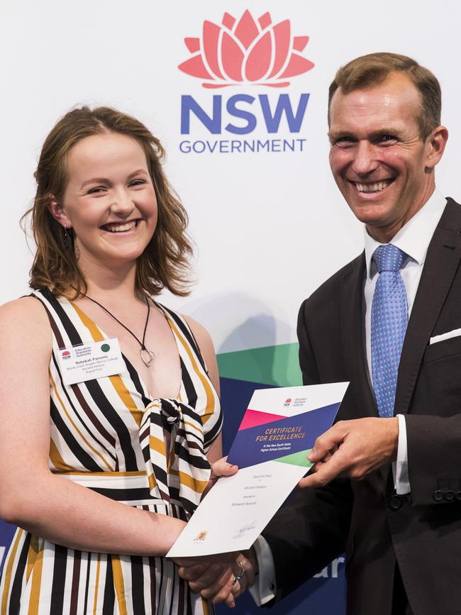 Collaroy Plateau’s Rebekah Parsons of Monte Sant’ Angelo Mercy College receives equal first place for Ancient History from Education Minister Rob Stokes. Photo: Anna Warr