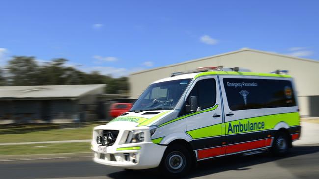 Paramedics assess four patients in a head-on collision in Logan on Saturday.