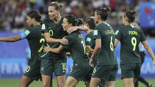 Matildas players celebrate after Sam Kerr (left) scored the team’s third goal against Brazil. Picture: AP