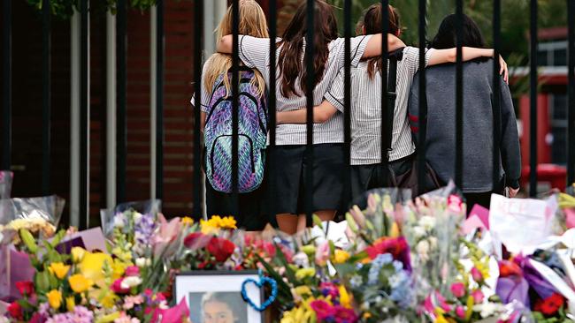 Marsden State High School students place flowers and teddy bears outside their school gate for Tiahleigh Palmer in 2015. Picture: Jack Tran