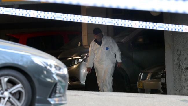 Officers comb the area for evidence. Picture: Richard Dobson