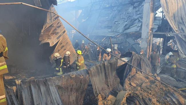 Rescuers sift through the remains of the mall hit by a Russian missile strike in the eastern Ukrainian city of Kremenchuk. Picture: AFP