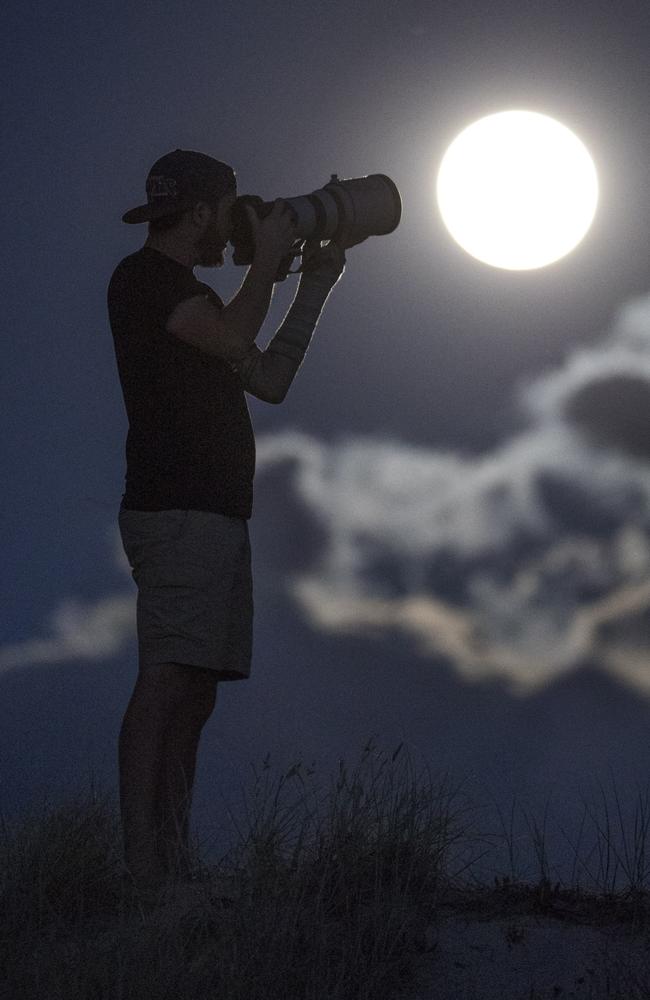 Tim Braitling watching the Supermoon at the Gold Coast Spit. Picture: Peter Wallis