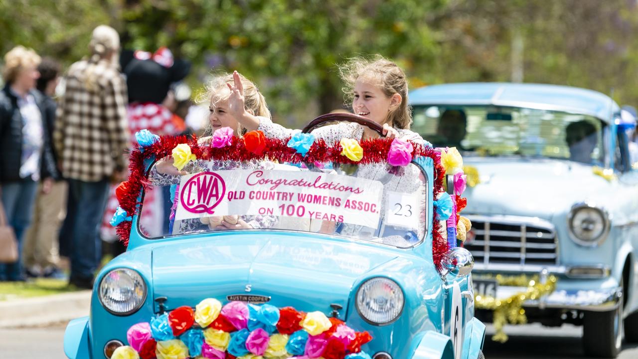 Driving in the Jacaranda Day grand parade in Goombungee is 10-year-old Chloe Brazier (behind the steering wheel) with her six-year-old sister Sophie, Saturday, November 5, 2022. Picture: Kevin Farmer