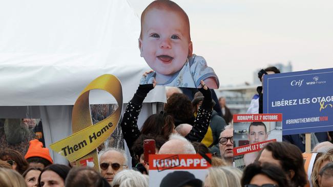 An attendee holds a portrait placard of Israeli hostage Kfir Bibas during a gathering in tribute to Israeli hostages, called by the Representative Council of French Jewish Institutions (CRIF) at the Trocadero square in Paris on February 21, 2025. Picture: GEOFFROY VAN DER HASSELT / AFP