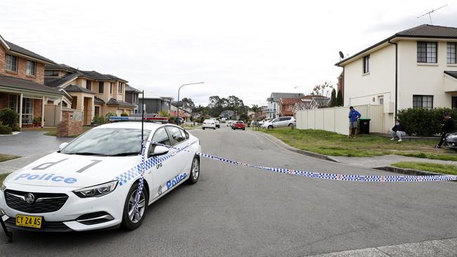 Police on the Sydney street in which the fifth death of the latest NSW outbreak has been confirmed. Picture: Jonathan Ng