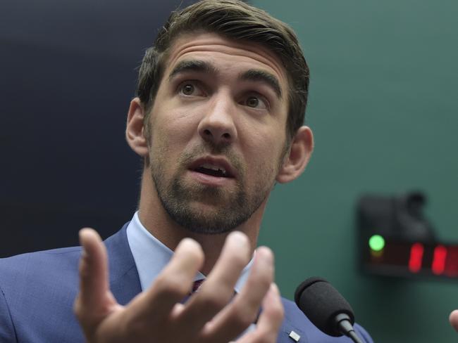 FILE - In this Feb. 28, 2017, file photo, swimmer Michael Phelps testifies on Capitol Hill in Washington, before the House Commerce Energy and Commerce subcommittee hearing on the international anti-doping system. Michael Phelps is watching the world championships from afar, enjoying his ever-growing family while tackling the challenges of life after swimming. But the winningest athlete in Olympic history is still passionate about the sport that meant so much to his life. And, yes, he still gets angry when the subject turns to the scourge of doping. (AP Photo/Susan Walsh, File)