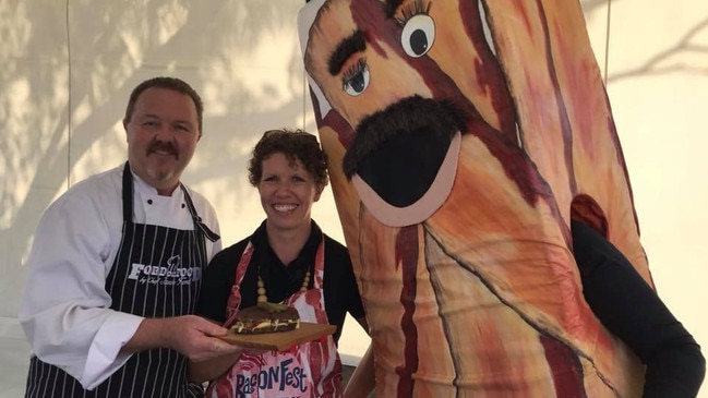 South Burnett chef Jason Ford shares his Rueben bacon sandwich with Kathryn Stevens and BaconMan at BaconFest.