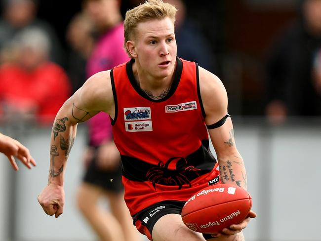 Corey Pertzel of Romsey handballs during the round 16 Riddell District Football Netball League 2023 Bendigo Bank Seniors match between Romsey and Macedon at Romsey Park in Romsey, Victoria on August 5, 2023. (Photo by Josh Chadwick)