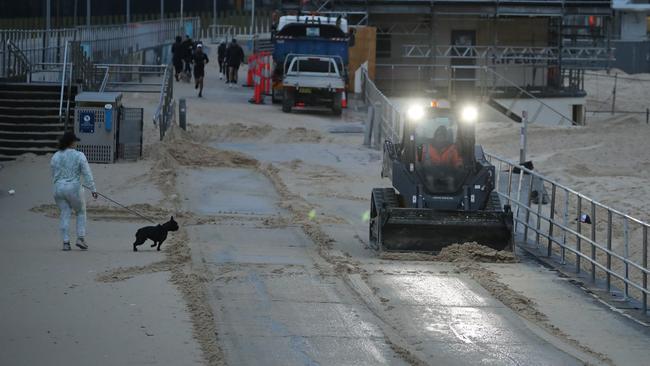 Layers of sand have blanketed the main beachfront walkway at Bondi Beach. Picture: John Grainger