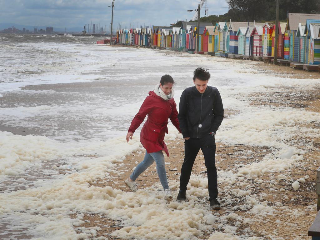 MELBOURNE, AUSTRALIA - NewsWire Photos, NOVEMBER 21, 2022. Wild and cold weather hits Melbourne and much of Victoria. Brighton bathing boxes surrounded by high waves and sea foam. Picture: NCA NewsWire / David Crosling