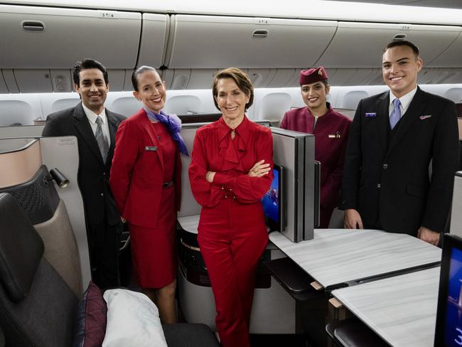 BRISBANE, AUSTRALIA - DECEMBER 04: In this image released on December 12, Jayne Hrdlicka, CEO of Virgin Australia, joins crew from both Virgin Australia and Qatar Airways onboard a Qatar Airways Boeing 777 at Brisbane Airport on December 04, 2024 in Brisbane, Australia. A new partnership between the two airlines has been launched which will deliver more value and choice to Australians, providing opportunities to travel to over 100 destinations across Europe, the Middle East and Africa. From December 12, Aussies can book Virgin Australia's new direct services from Sydney, Brisbane and Perth to Doha for travel from June 2025, with Melbourne set to launch later in 2025. These flights will be operated by Virgin Australia using Qatar Airways' spacious Boeing 777s, renowned for their Qsuite Business Class. (Photo by James D. Morgan/Getty Images for Virgin Australia)