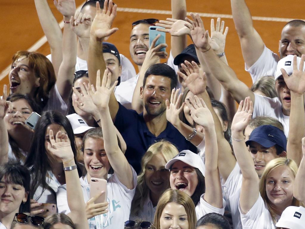 Novak Djokovic poses with volunteers and players after the Adria Tour charity tournament.