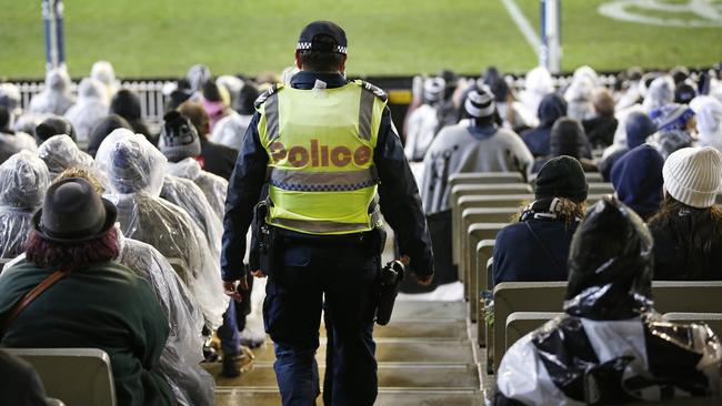 A police officer patrols the aisles for trouble during the Collingwood vs Richmond game. Picture: David Caird