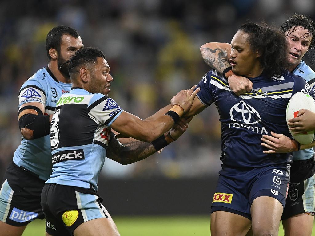 Luciano Leilua fends off the Sharks. Picture: Ian Hitchcock/Getty Images